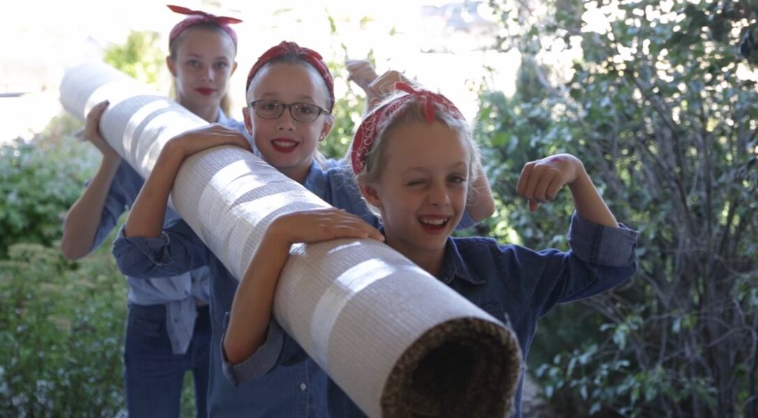 3 daughters holding carpet roll | IQ Floors