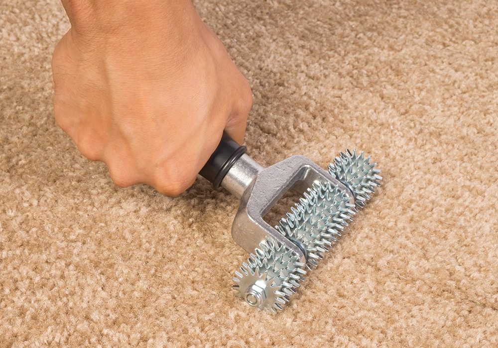 Worker installing carpet | IQ Floors